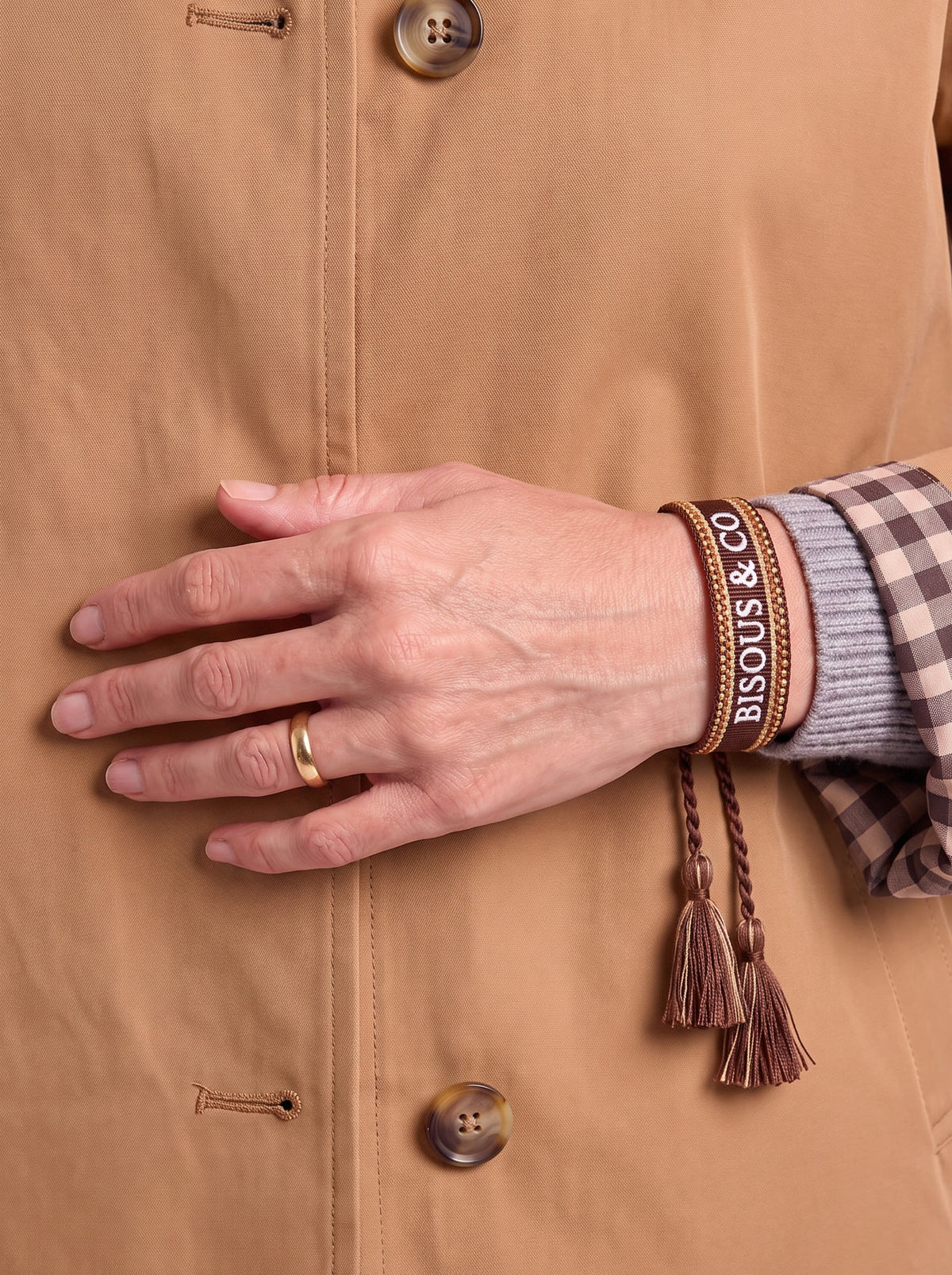 The Paris Bracelet — Chocolate Brown, worn at the cuff of The London Trench