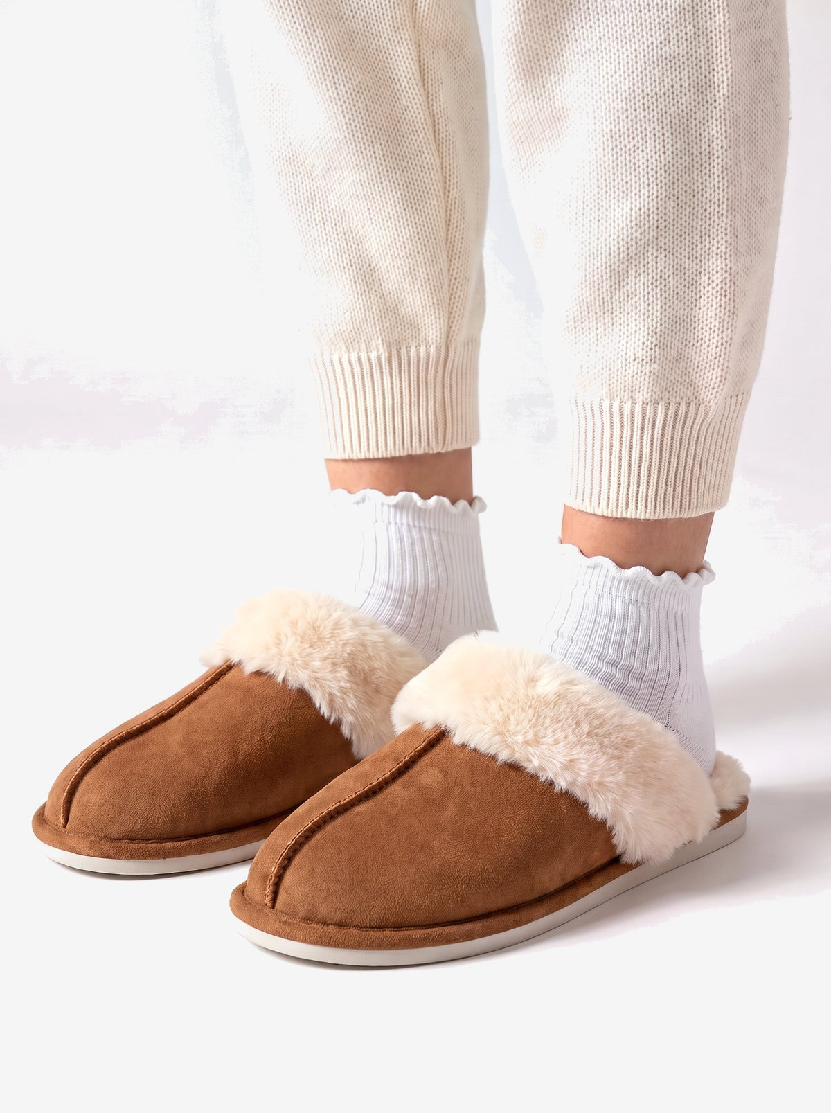 The Courchevel Slipper in Chestnut, worn with white ruffle socks