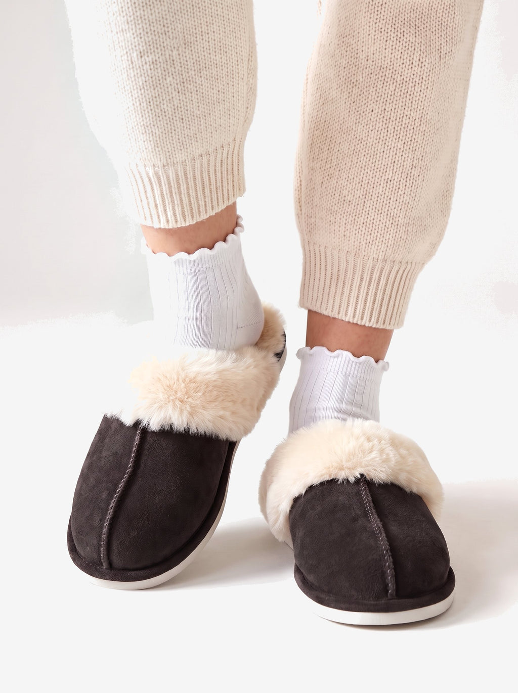 The Courchevel Slipper in Espresso, worn with white ruffle socks