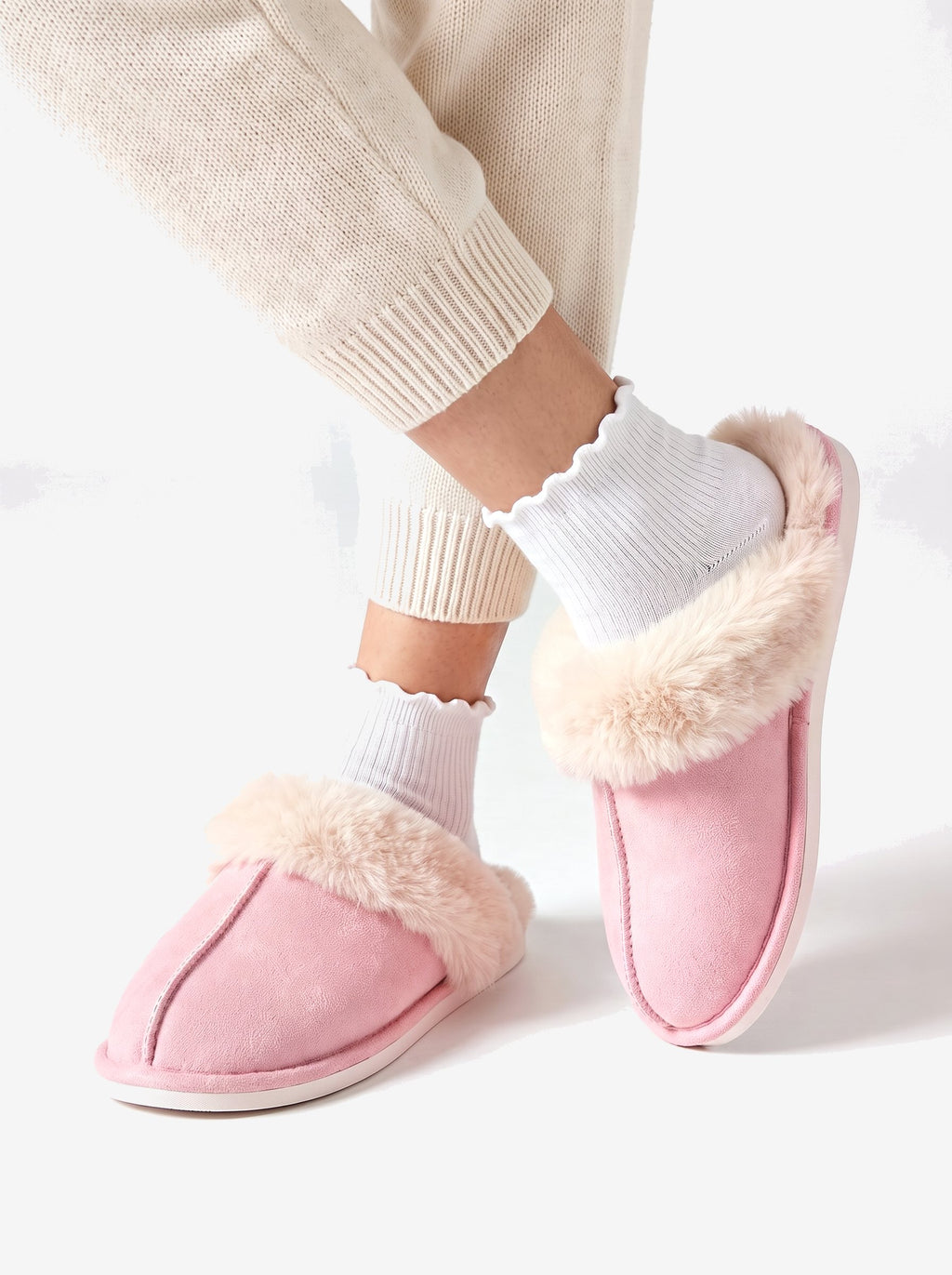 The Courchevel Slipper in Pink, ankles crossed